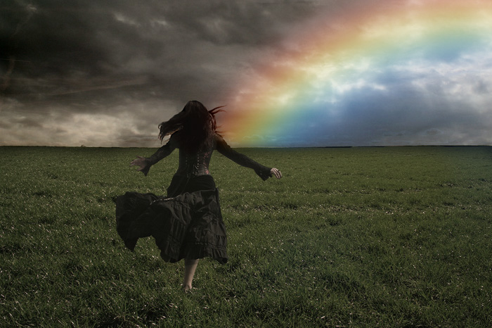 woman running to rainbow